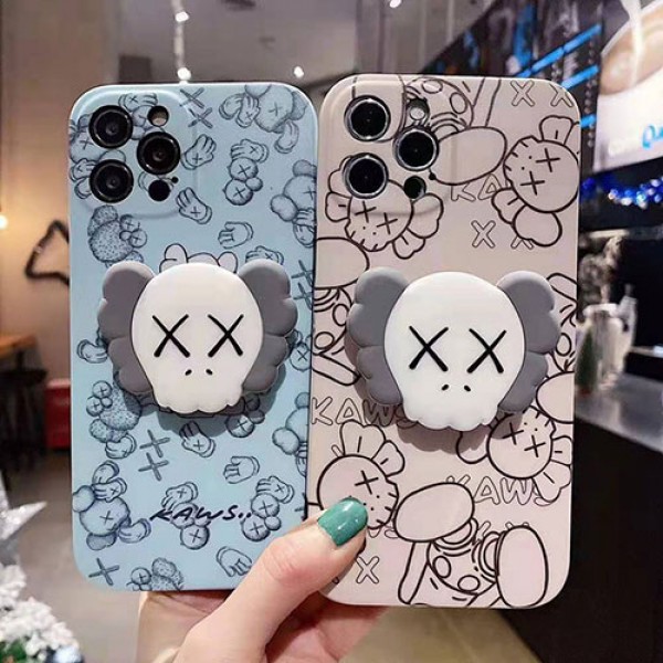 カウズ ブランドiphone12/12pro max/12 mini/12 pro maxケース ハンドバンド付き 韓国風 ホルダー付 KAWS 個性潮 iphone x/xr/xs/xs maxケース 落下防止 ファッション ins風 iphone 11/11 pro/11 pro maxケース かわいい iphone x/8/7 plusケース大人気